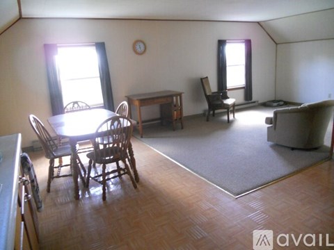 A living room with a dining table and chairs.