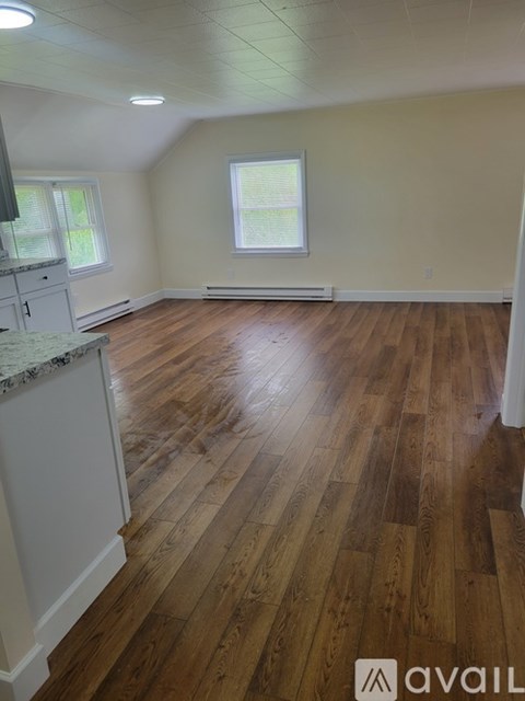 A room with wooden floors and a window.