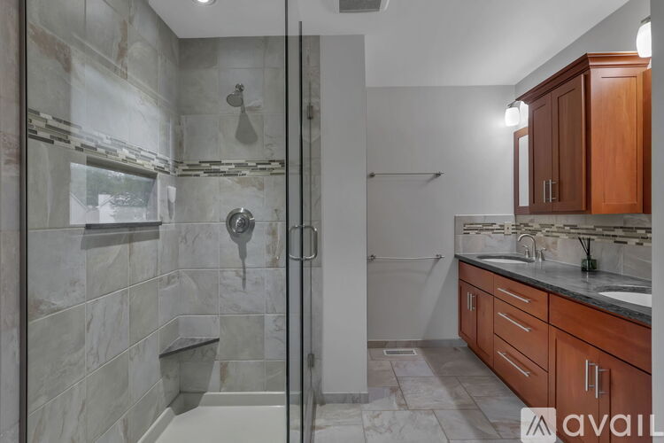 A bathroom with a walk-in shower and a sink.