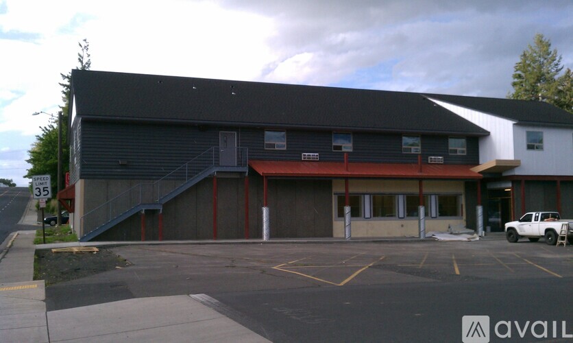A building with a parking lot in front of it.