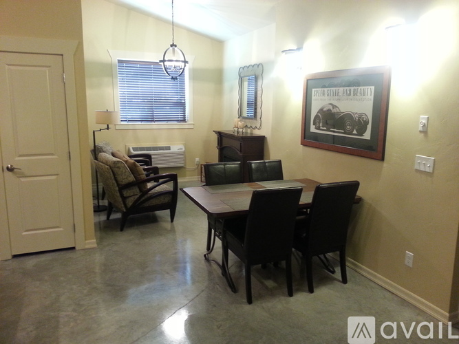 A dining room with a wooden table and chairs.