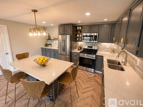 A modern kitchen with a dining table and chairs.