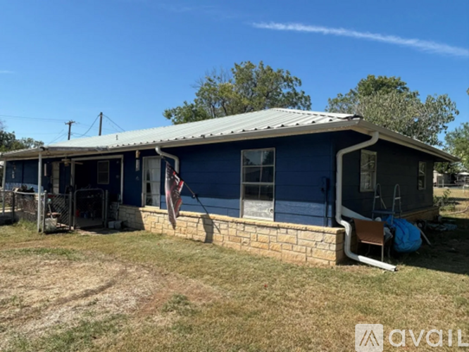 A blue house with a flag hanging outside.