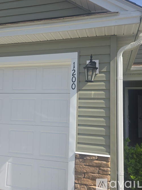 A white garage door with the number 1200 on it.