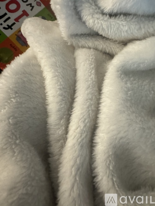 A close up of a white fluffy blanket.