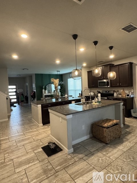 A kitchen with a large island in the middle of the room.