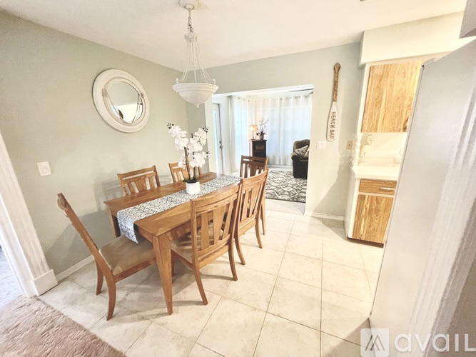 A dining room with a wooden table and chairs.