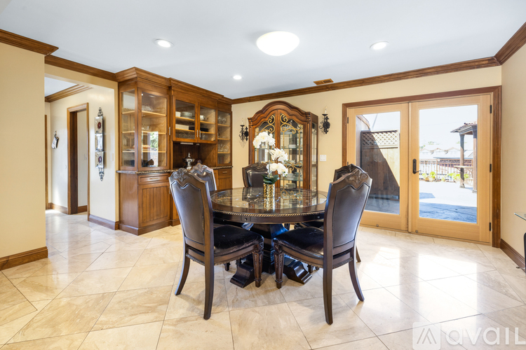 A dining room with a table set for four.