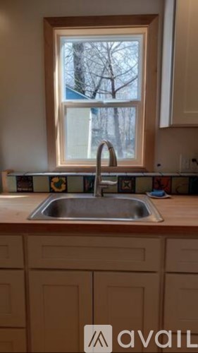 A kitchen with a sink under a window.