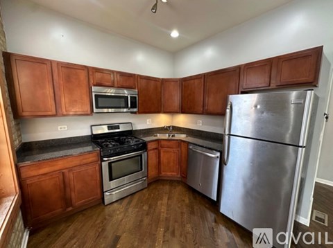A kitchen with wooden cabinets and stainless steel appliances.