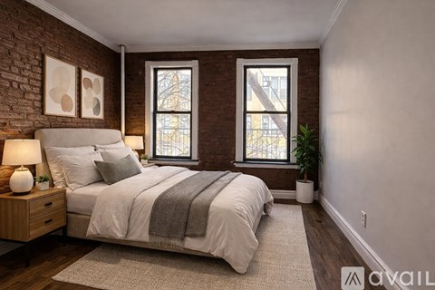 A bedroom with a bed, nightstand, and two windows.