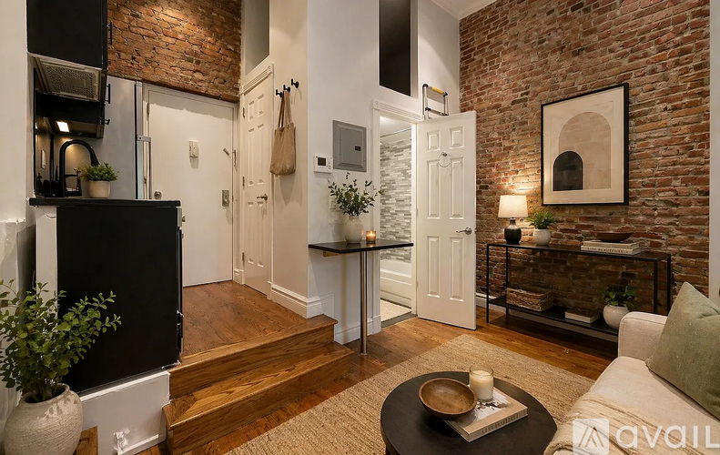 A living room with a brick wall and a white door.