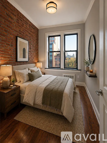 A bedroom with a brick wall and a large bed.