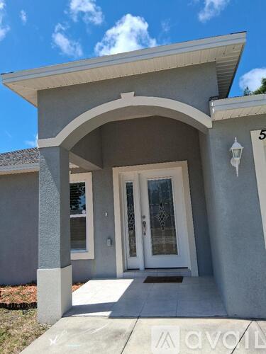 A house numbered 5 has a white door and a small porch.