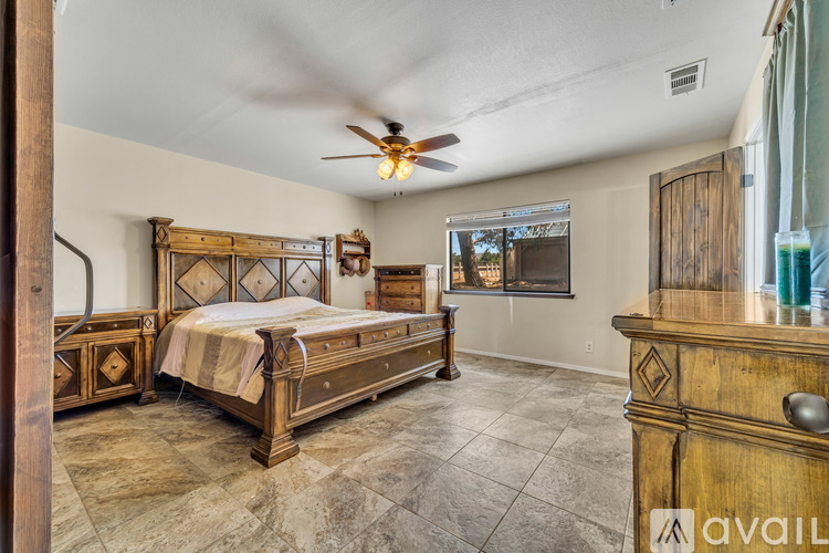 A bedroom with a large bed and a dresser.
