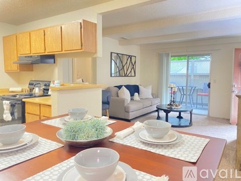 A kitchen with a dining table set for two.