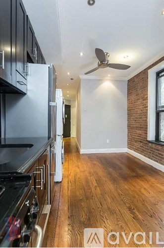 A kitchen with a stove top oven and a refrigerator.