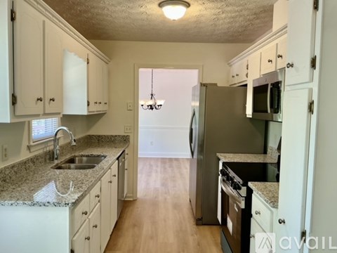 A kitchen with granite countertops and stainless steel appliances.