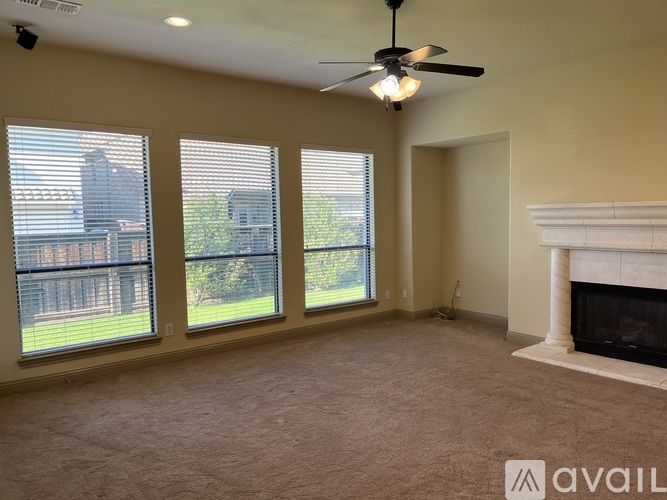 A room with a fireplace and a ceiling fan.