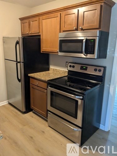 A kitchen with a stove top oven and microwave above it.
