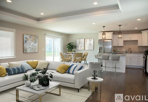 A modern living room with a white sofa and a coffee table.