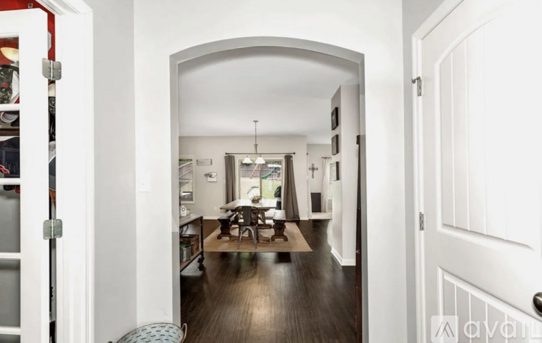 A hallway with a dining area at the end.
