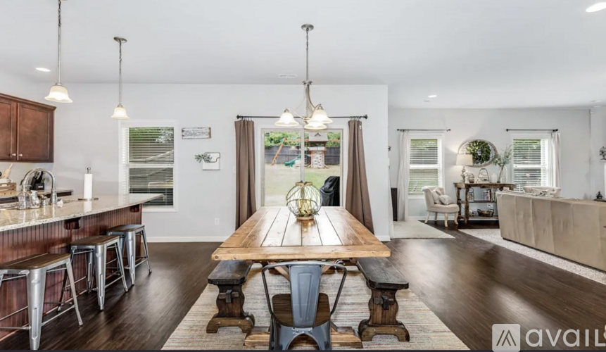 A modern dining room with a wooden table and chairs.