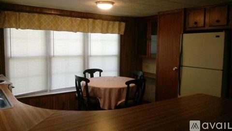A dining area with a table and chairs is available.