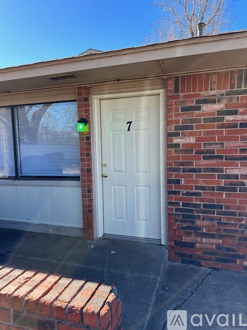 A white door with a green sign above it that says 7.
