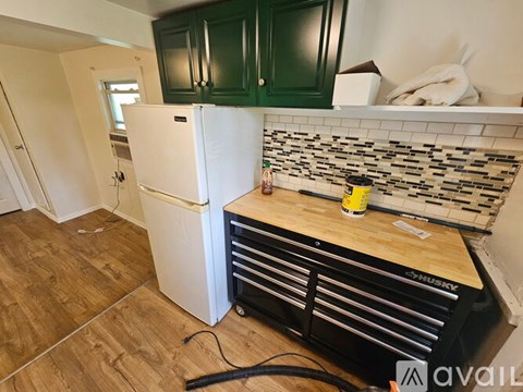 A kitchen with a white fridge and wooden countertop.
