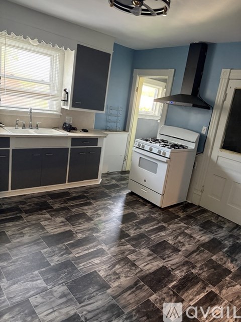 A kitchen with a black and white checkered floor.