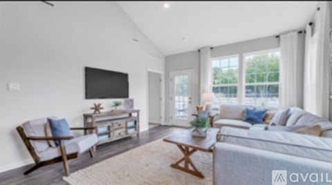 A living room with a wooden chair and a white couch.
