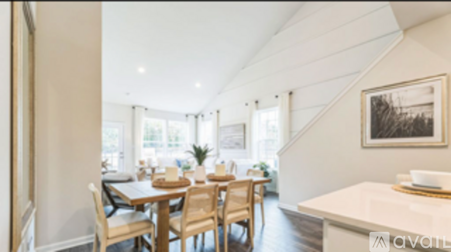 A dining room with a table set for six people.