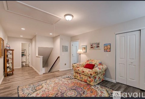 A living room with a sofa and a rug.
