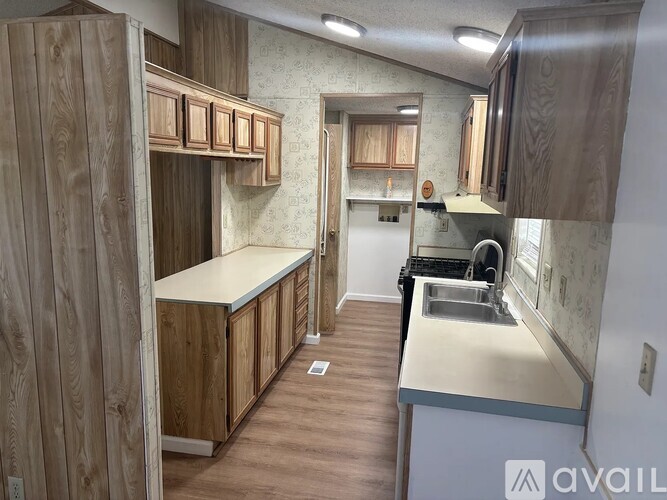 A kitchen with wooden cabinets and a white countertop.