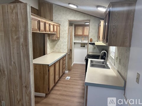 A kitchen with wooden cabinets and a white countertop.