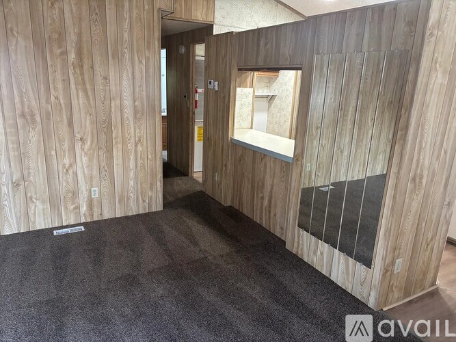 A room with wooden walls and a carpeted floor.