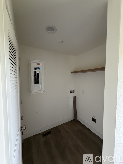 A room with a white door and a white wall.