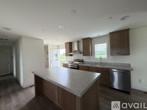 A kitchen with a large island in the middle.