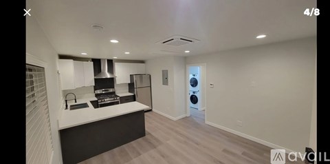 A modern kitchen with a stove top oven and a refrigerator.