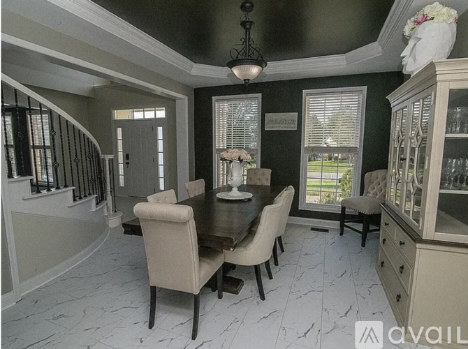 A dining room with a table set for four.
