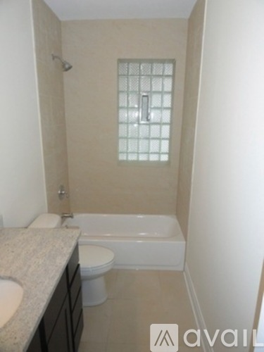 A bathroom with a toilet, sink, and bathtub.