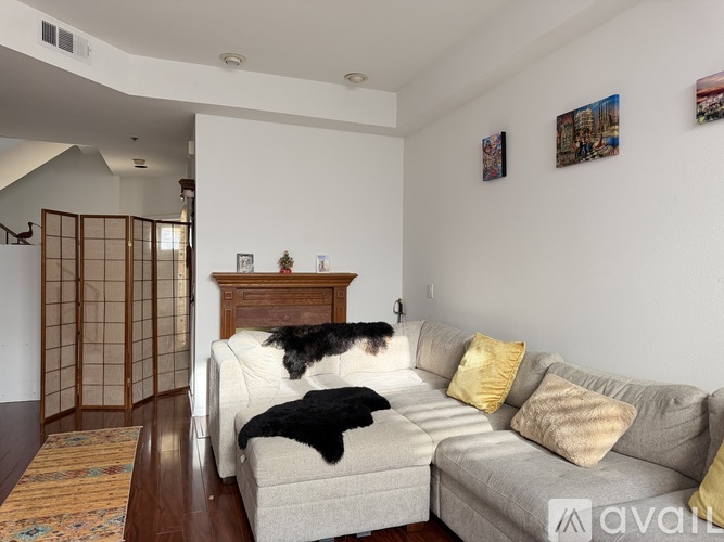 A living room with a couch and a dog on it.