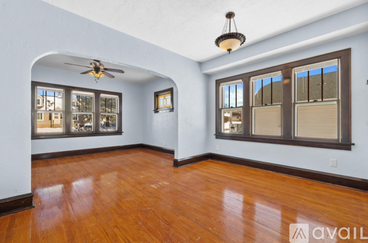 A room with wooden floors and a ceiling fan.