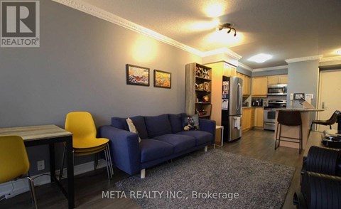 A living room with a blue couch and a yellow chair.