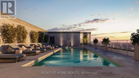 A pool area with lounge chairs and a building in the background.