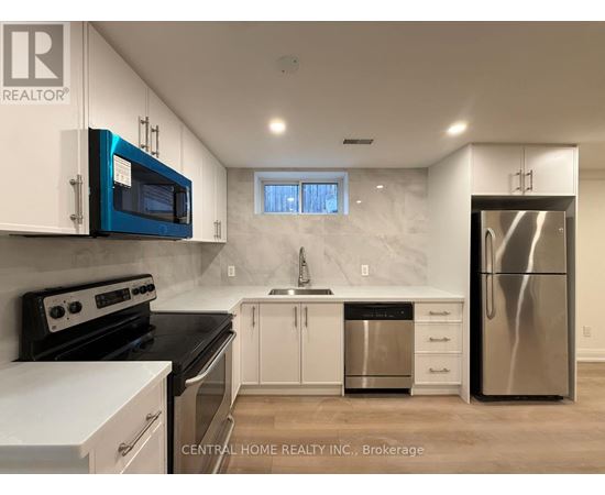 A kitchen with white cabinets and a blue microwave.