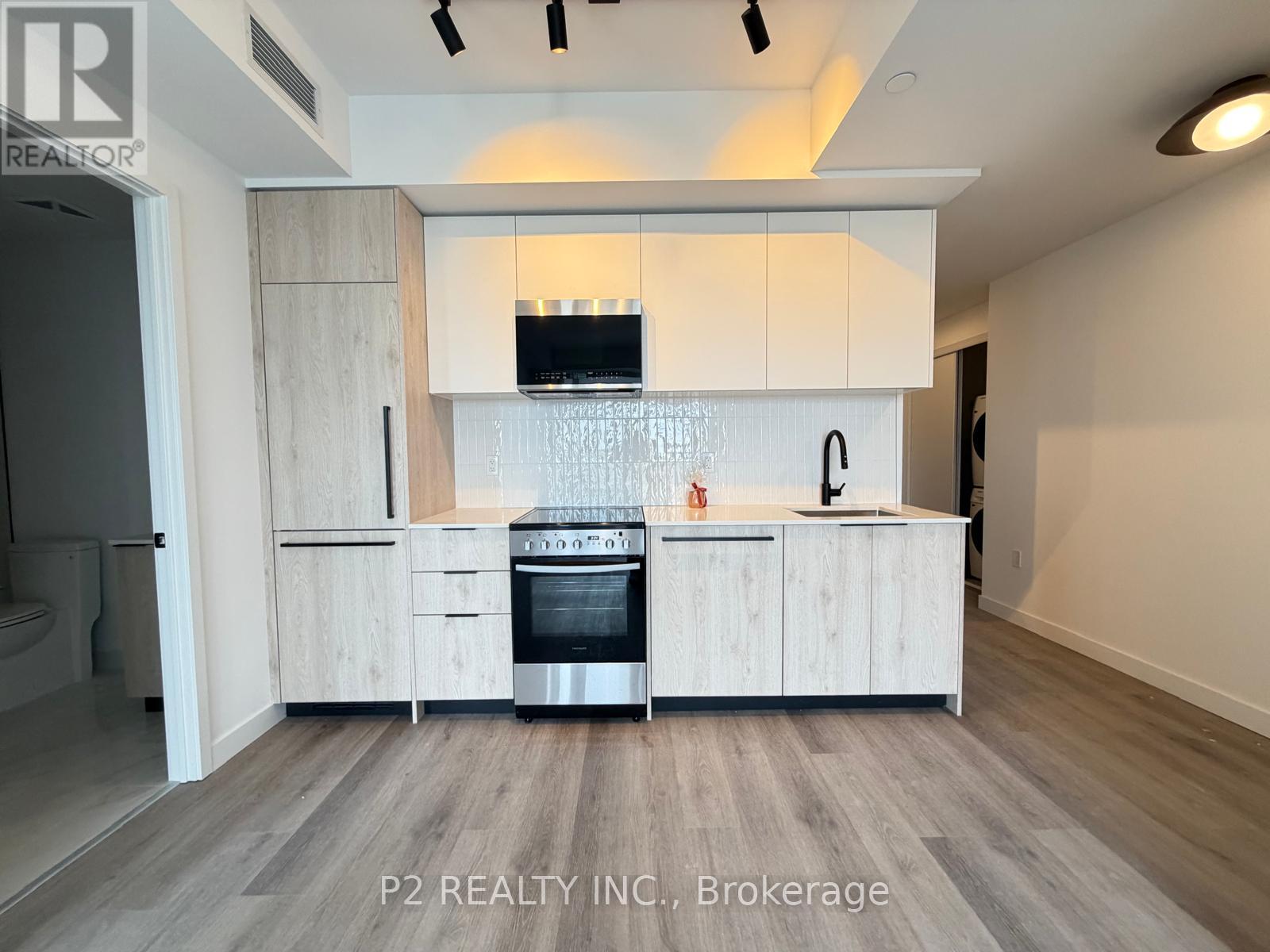 A modern kitchen with white cabinets and a wooden island.