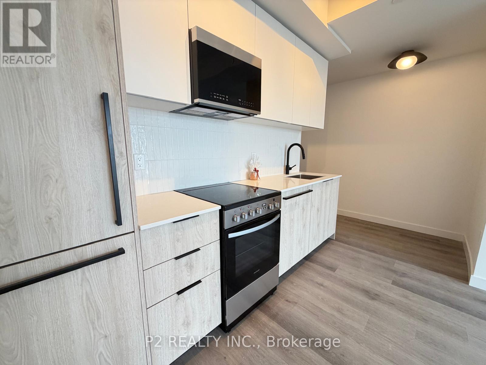 A kitchen with a microwave above the stove.