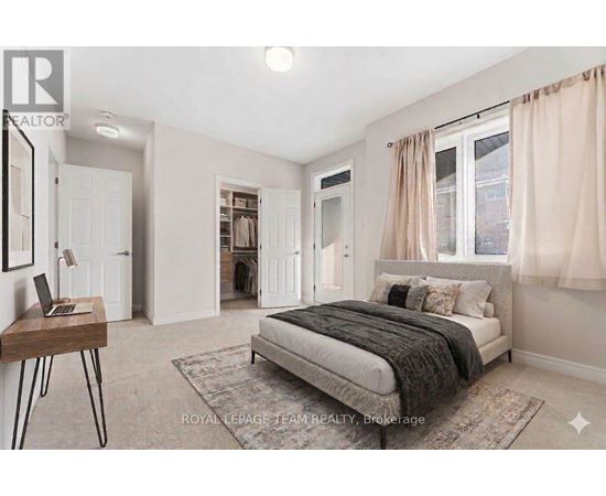 A bedroom with a bed, desk, and chair.